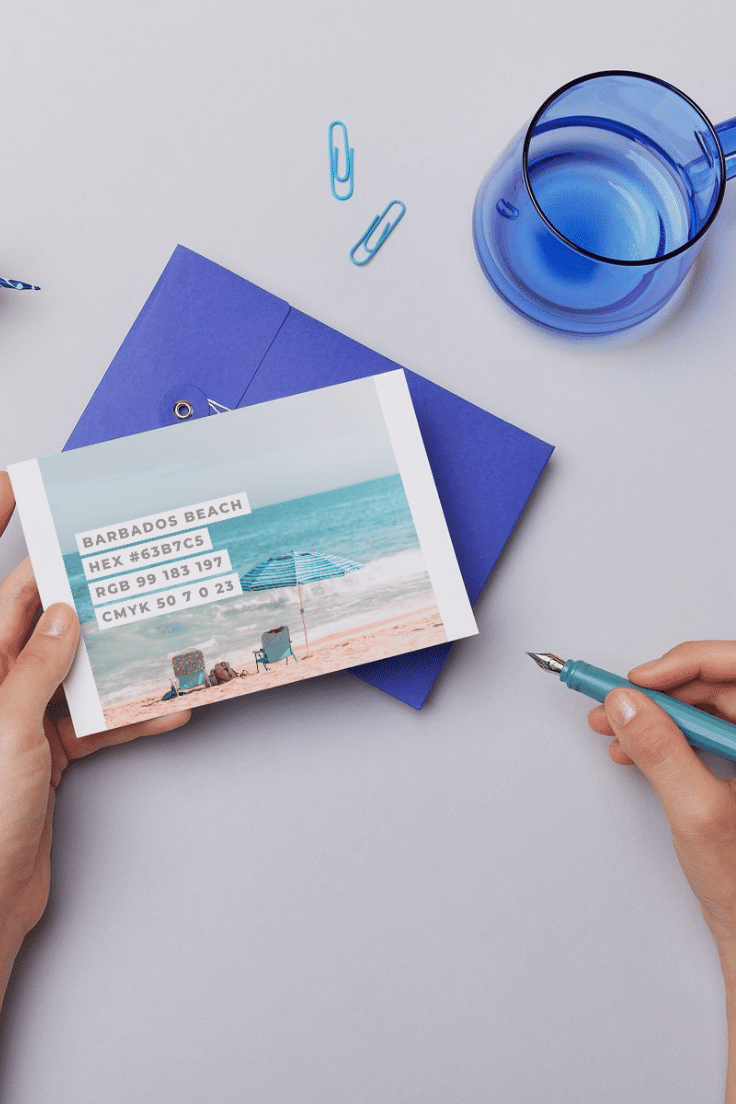 Beach Sunset Premium Canva Color Palette 5 one hand holding a postcard of canva beach sunset color palette and another hand holding a pen