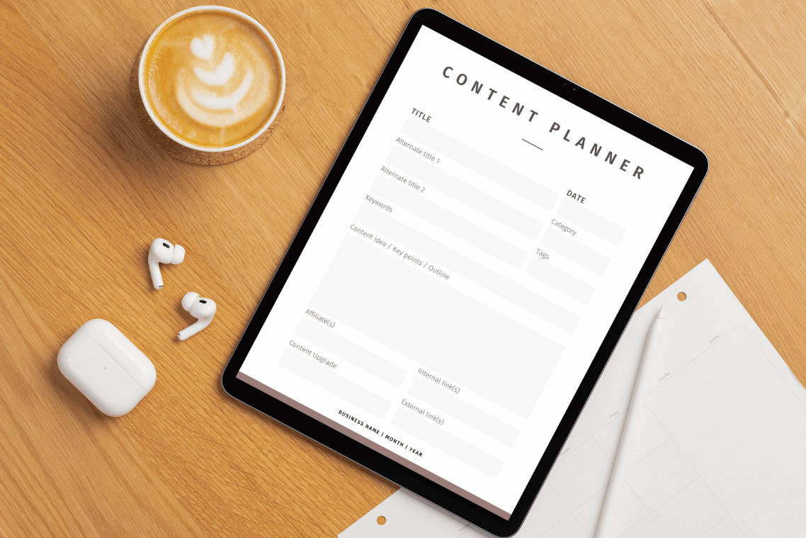 content planner in a tablet with coffee and ear pods